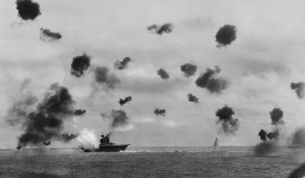 a boat and explosions over the water during the battle of Guadalcanal